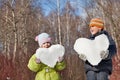 Boy and girl keeps in hands hearts from snow Royalty Free Stock Photo