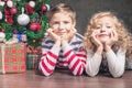 Boy and girl lying on the floor under Christmas tree Royalty Free Stock Photo