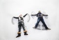 Boy and girl making snow angels Royalty Free Stock Photo