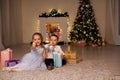 A boy with a girl open Christmas presents new year holiday Garland lights Royalty Free Stock Photo