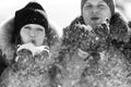 Boy and girl outdoors on a winter walk playing snowballs