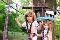 Boy and a girl pass an obstacle course in a rope park Royalty Free Stock Photo