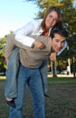 Boy and girl piggy back riding