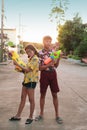 Boy and girl play water gun together on Songkran festival in Thai Royalty Free Stock Photo