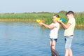 Boy and girl play with water pistols on the river Royalty Free Stock Photo