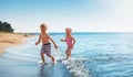 Boy and girl playing on the beach on summer holidays Royalty Free Stock Photo