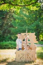 Boy and girl playing in a cardboard boat Royalty Free Stock Photo