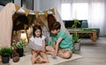 Boy and girl playing in a diy tent at home