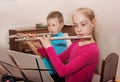 A boy and a girl playing the flute Royalty Free Stock Photo