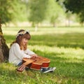 Boy and girl playing guitar in summer park Royalty Free Stock Photo