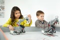 Boy and girl playing with a handmade robot. DIY robotics projects, fun and development, after school leisure Royalty Free Stock Photo