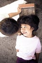 Boy and girl playing happily outdoors in a village despite poor living Royalty Free Stock Photo