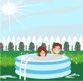 Boy and girl playing in inflatable baby pool Royalty Free Stock Photo