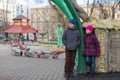 Boy and girl playing in the playground with sculptures Royalty Free Stock Photo