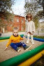 Boy and girl playing in sandbox Royalty Free Stock Photo