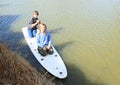 Boy and girl playing on surf Royalty Free Stock Photo