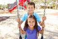 Boy And Girl Playing On Swing In Park Royalty Free Stock Photo