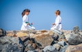 Boy and girl practising yoga on beach Royalty Free Stock Photo