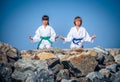 Boy and girl practising yoga on beach Royalty Free Stock Photo