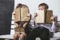 Boy and girl from primary school class on the bench read books o Royalty Free Stock Photo