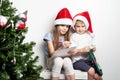 Boy and a girl in a red cap write a letter to Santa Claus Royalty Free Stock Photo