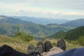 Boy and girl relaxing under the sun.Man and woman lying on sunbed and looking at beautiful background,snow mountains and clouds.Ha Royalty Free Stock Photo