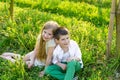 A boy and a girl are resting in a blooming garden in the spring Royalty Free Stock Photo