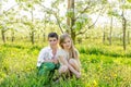 A boy and a girl are resting in a blooming garden in the spring Royalty Free Stock Photo