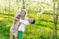 A boy and a girl are resting in a blooming garden in the spring Royalty Free Stock Photo