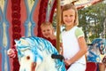 Boy and girl ride on the carousel