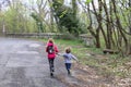 Boy and girl running or hike through the forest in early spring Royalty Free Stock Photo