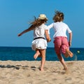 Boy and girl running towards sea. Royalty Free Stock Photo