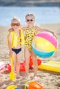 Boy and girl on a sandy beach with a large inflatable ball Royalty Free Stock Photo