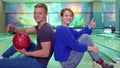 Boy and girl show their thumbs up at the bowling
