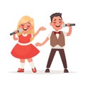 Boy and a girl sing a song into a microphone. Children`s musical Royalty Free Stock Photo