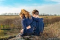 A boy and a girl are sitting on a cliff, two friends, a brother and a sister, are hugging each other. Royalty Free Stock Photo