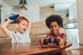 Boy and girl sitting in living room playing video game together Royalty Free Stock Photo