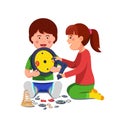 Boy and girl sitting playing with mechanical clock