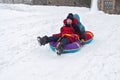 Boy and girl sledding from the mountain. emotional joyful and long-standing brother and sister spend together in winter Royalty Free Stock Photo