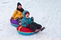 Boy and girl sledding from the mountain. emotional joyful and long-standing brother and sister spend together in winter Royalty Free Stock Photo
