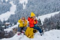 Boy and girl sledding in a snowy forest. Outdoor winter kids fun for Christmas and New Year. Children enjoying a sleigh Royalty Free Stock Photo