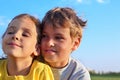 Boy and girl smile and look toward Royalty Free Stock Photo