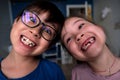 A boy and a girl smile toothless smiles. Royalty Free Stock Photo