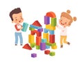 Boy and girl are smiling and building a tower of children`s blocks. Children play friendly and fun together Royalty Free Stock Photo
