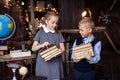 Boy and girl with a stack of books comes from the library. Smart schoolboy and schoolgirl. Literature lesson Royalty Free Stock Photo