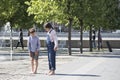 Boy and girl stand barefoot near fountain