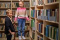 boy and girl stand talking in library Royalty Free Stock Photo
