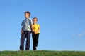 Boy and girl stand together on grass