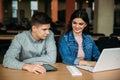 Boy and girl study in library use laptop and help each other Royalty Free Stock Photo