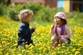 Boy and girl in summer flowers field Royalty Free Stock Photo